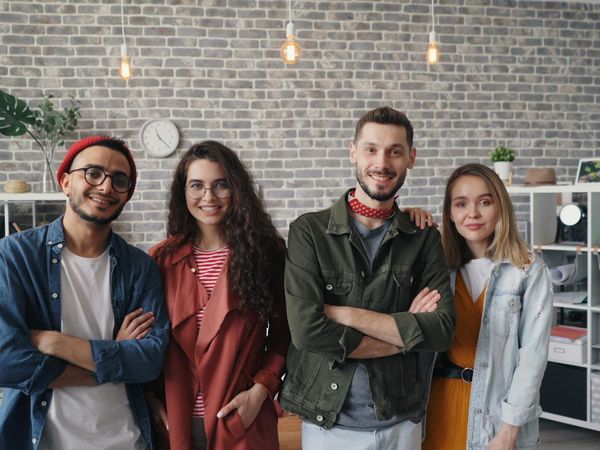 A group of people in a bright, modern studio, looking energized and happy after a workout.